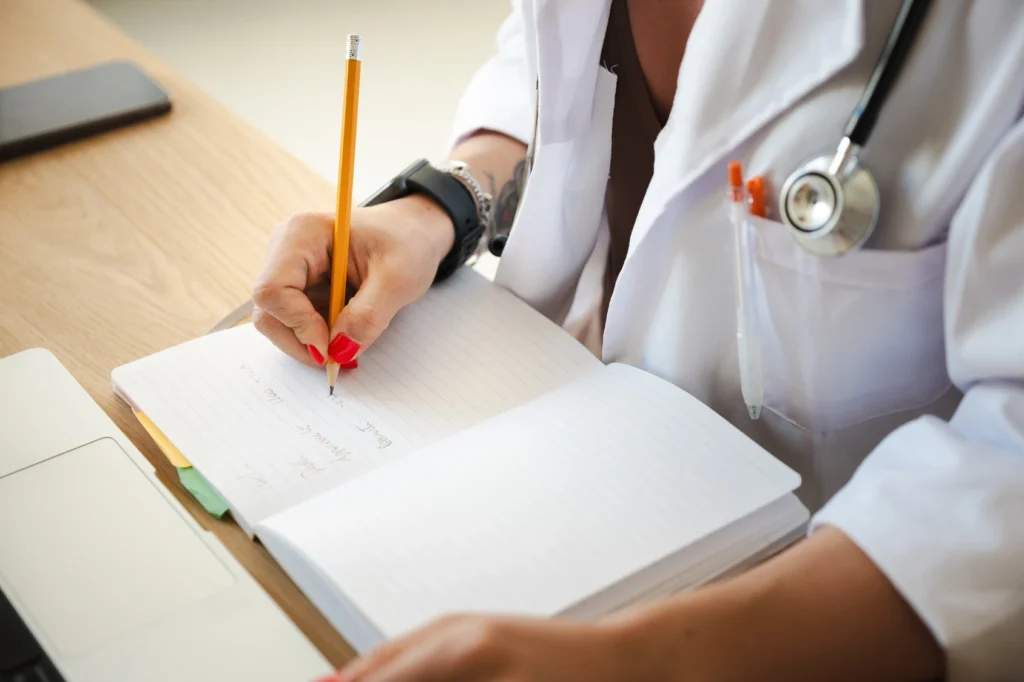 doctor writing in notebook