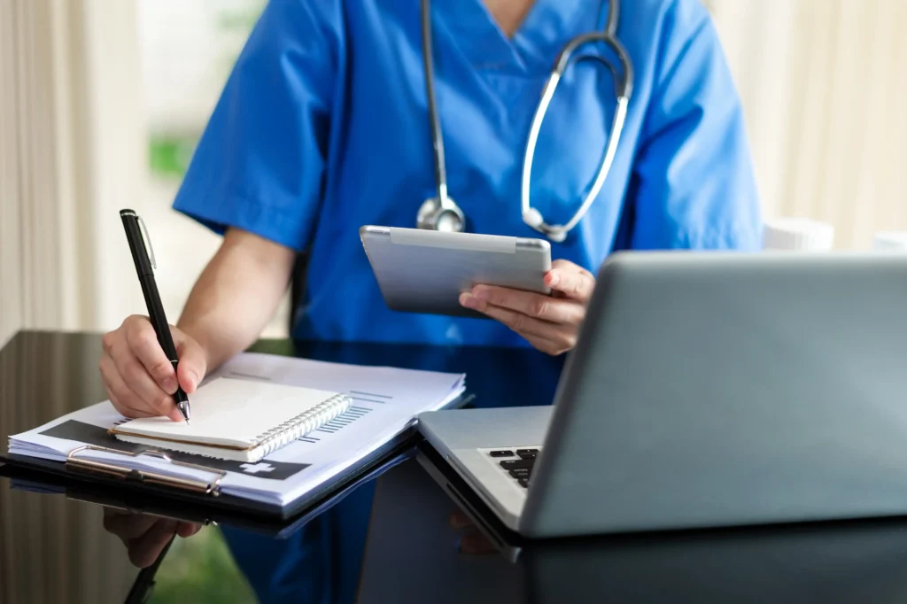 doctor with tablet writing